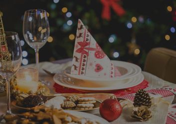 A Christmas plate and glass adorned with festive holiday decorations.