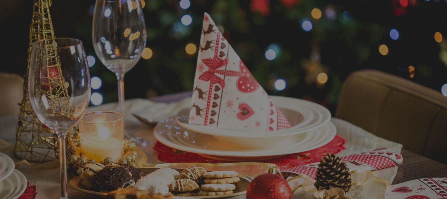 A Christmas plate and glass adorned with festive holiday decorations.
