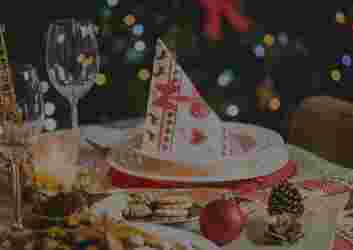 A Christmas plate and glass adorned with festive holiday decorations.